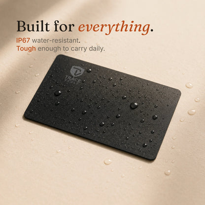Trace Vault tracking card with water droplets on a beige surface, showing its water-resistant design for everyday durability.