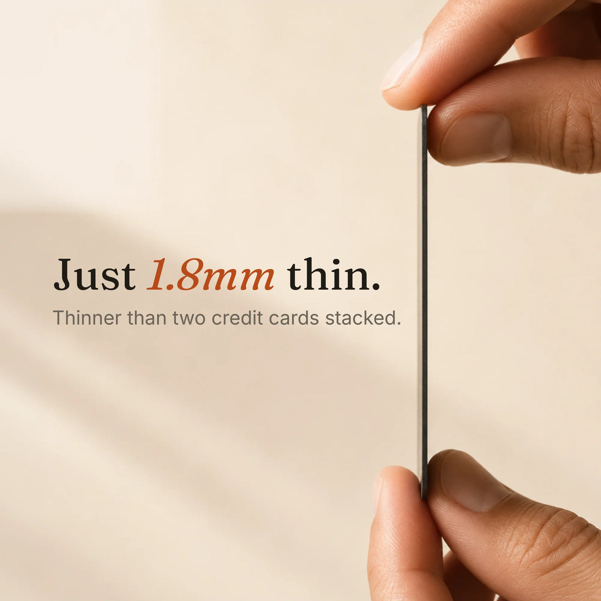 Close-up of a Trace Vault tracking card showing its ultra-thin 1.8mm design held between two hands.
