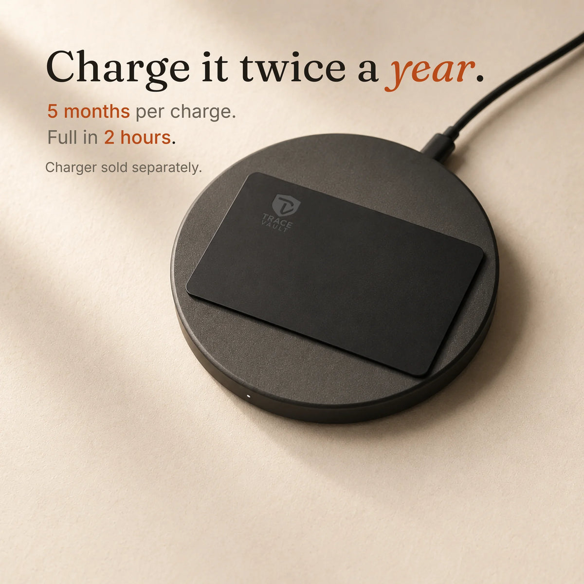 Trace Vault tracking card placed on a black wireless charging pad with the Trace Vault logo, showing convenient wireless charging.